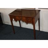 An oak lowboy with three drawers and shaped kneehole, on square tapered legs, 79cm