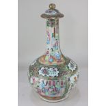 A Chinese Cantonese bottle vase with cover, decorated in famille rouge colours, with panels of