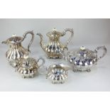 A five-piece silver plated tea and coffee set of melon form
