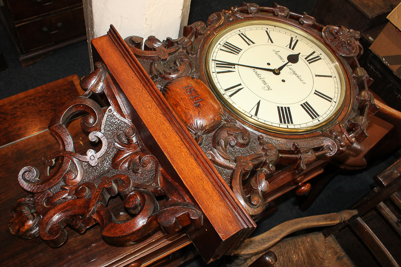 A Victorian wall clock with 14 inch circular dial marked James Langelaan, Godalming, in ornately
