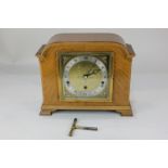 A 20th century walnut cased mantel clock, the square gilt dial marked Pearce & Sons Ltd,