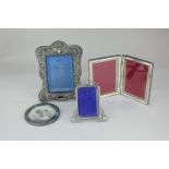 An Edward VII silver folding double photograph frame, maker King & Sons, Chester 1903, for