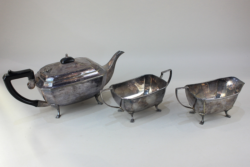 A silver plated three-piece tea set of teapot, sugar bowl, milk jug, rectangular form, each on