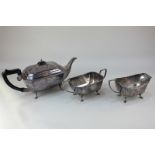 A silver plated three-piece tea set of teapot, sugar bowl, milk jug, rectangular form, each on