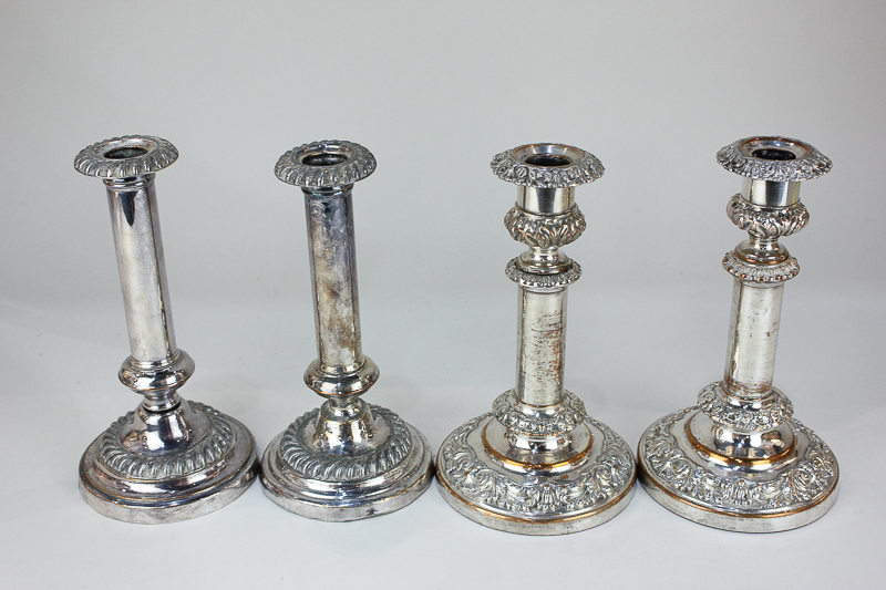 Two pairs of silver plated column candlesticks, one pair telescopic with embossed scroll design,