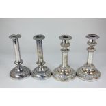 Two pairs of silver plated column candlesticks, one pair telescopic with embossed scroll design,