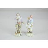 A pair of Dresden miniature porcelain figures of a gallant and lady, standing on scroll bases, 11cm