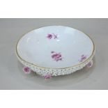 A Meissen porcelain circular bowl decorated with pink flowers and underside encrusted with petals