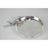 A George V unusual silver dish, mounted with an elfin figure chasing a spider (a/f - one let