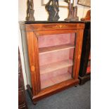 A Victorian inlaid rosewood pier cabinet with single glazed door, on plinth base and turned feet,