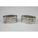 A pair of Continental silver napkin rings, oval shape with pierced sunburst design 'Moi' and 'Toi'