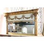 A giltwood and gesso over-mantel mirror with ribbon and floral swag panel above rectangular bevelled