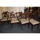 A set of eight Regency style mahogany dining chairs, including two carvers, with lyre shaped back