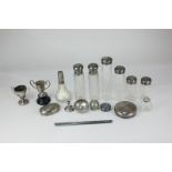 Eight silver mounted cut glass dressing table bottles, two EPNS trophy cups, a silver comb mount,