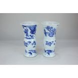 Two similar Chinese blue and white gu-shaped porcelain vases decorated with blossom and figures in a