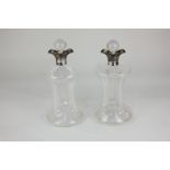 A matched pair of Victorian silver mounted decanters with pinched, waisted glass body and ball