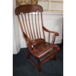 A farmhouse rocking chair with spindle back, scroll arms and solid seat (a/f), (LC)