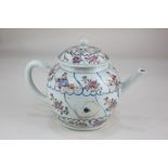 A Chinese famille rose porcelain teapot decorated with blue linear panels of figures and flowers