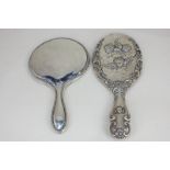 A George V silver backed hand mirror with floral border, maker Boots Pure Drug Company, Birmingham