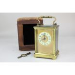A 19th century brass cased carriage clock with Arabic enamelled chapter ring, leather case (a/f),