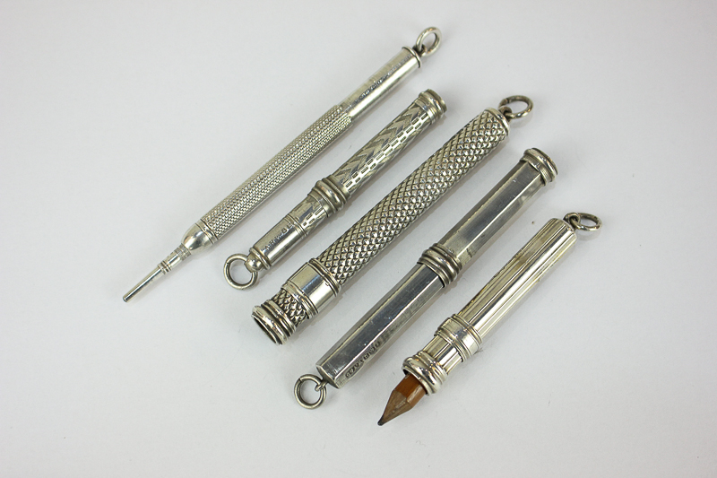 An S Mordan propelling pencil and four silver propelling pencil holders, in various styles of