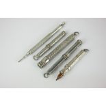 An S Mordan propelling pencil and four silver propelling pencil holders, in various styles of