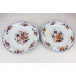 A pair of Chinese porcelain plates decorated with flowers in Imari colours (a/f), 22.5cm