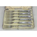 A cased set of six white metal dessert forks, the handles stamped 800