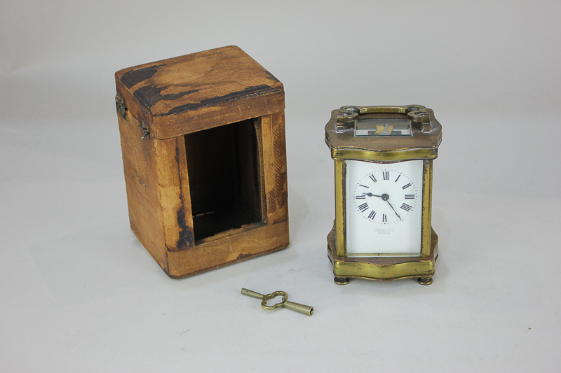 A brass and bevelled glass cased carriage clock, the dial marked Stewart & Co, 65a Gracechurch St,