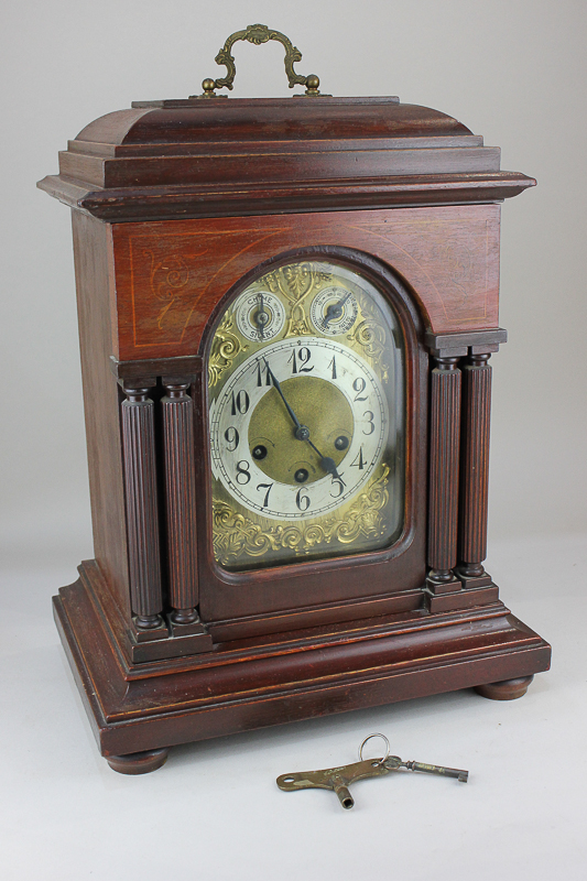 A Victorian mahogany chiming bracket clock with arched brass dial, silvered chapter ring, chime/