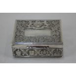 A Malaysian white metal cigarette box with overlaid and embossed design depicting military crests