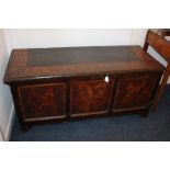 An oak poker work coffer, the top with decorative scroll border, the panels including griffins and