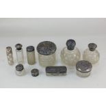 A Victorian silver pill box, together with nine silver mounted cut glass dressing table jars and