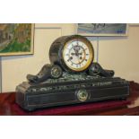A Victorian slate mantel clock with white enamel and brass dial, in drum shape case with scroll
