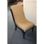 A Victorian upholstered slipper chair with ebonised frame, on turned front legs