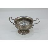 A Victorian silver two-handled sugar bowl with embossed floral design, maker Nathan & Hayes,