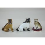 Three porcelain models of pug dogs, all with gilt ball collars, tallest 7cm