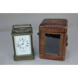 A brass and bevelled glass cased carriage clock, the white enamel dial marked Goldsmiths &