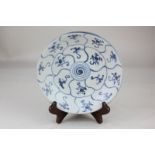 A Chinese Tek Sing blue and white porcelain dish with spiral decorated centre and floral panel