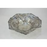 An Edward VII silver bowl of flared scalloped form, pierced and embossed floral swag design, maker