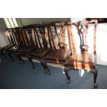 A set of six Chippendale style mahogany dining chairs with pierced ribbon scrolling foliate backs,