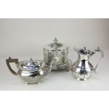 A silver plated oval biscuit box with engraved decoration, on claw feet, a demi fluted oval teapot