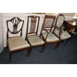 An Edwardian mahogany shield back salon chair with upholstered back and drop in seat, on tapered