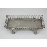 A 19th century Portuguese silver rectangular dish with pierced border, on claw and ball feet, marked