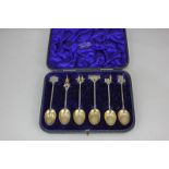A cased set of six Victorian silver gilt teaspoons, each with a London monument as a finial, maker