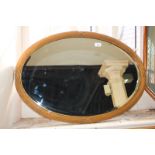 A giltwood and gesso oval wall mirror with fluted frame, 83cm high, (LC)
