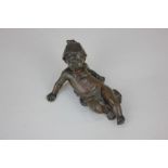 A 19th century bronze figure of a reclining child wearing a hat, the base impressed Lalouette, 5cm