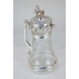 A silver plate mounted cut glass wine jug, the glass etched with vines and bunches of grapes, the