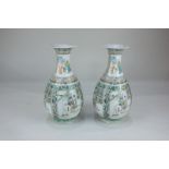 A pair of Chinese porcelain famille verte baluster vases decorated with figural panels within