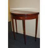 A Sheraton style mahogany demi-lune card table with banded lifting top (a/f - warped), on square